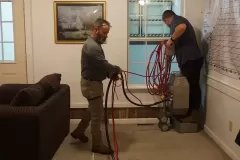 students removing water from the carpets